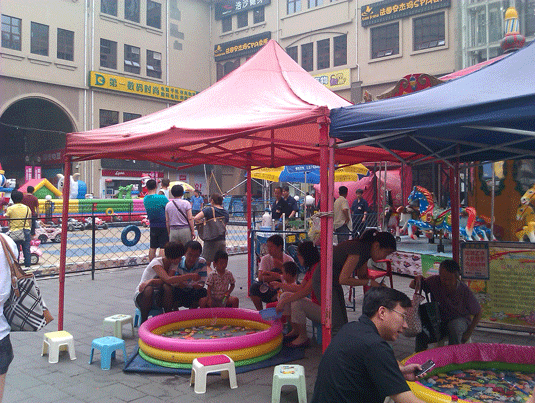 Children play in playground area located within department store area in Wangjing, city within a city, Beijing, China