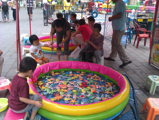 Children play in department store playground area, Wangjing, inside Beijing, China